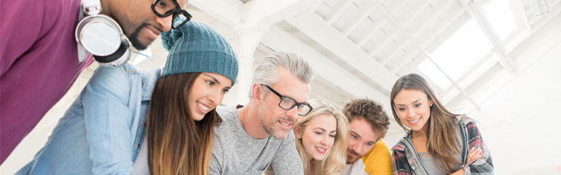a group of students with a tutor looking at work