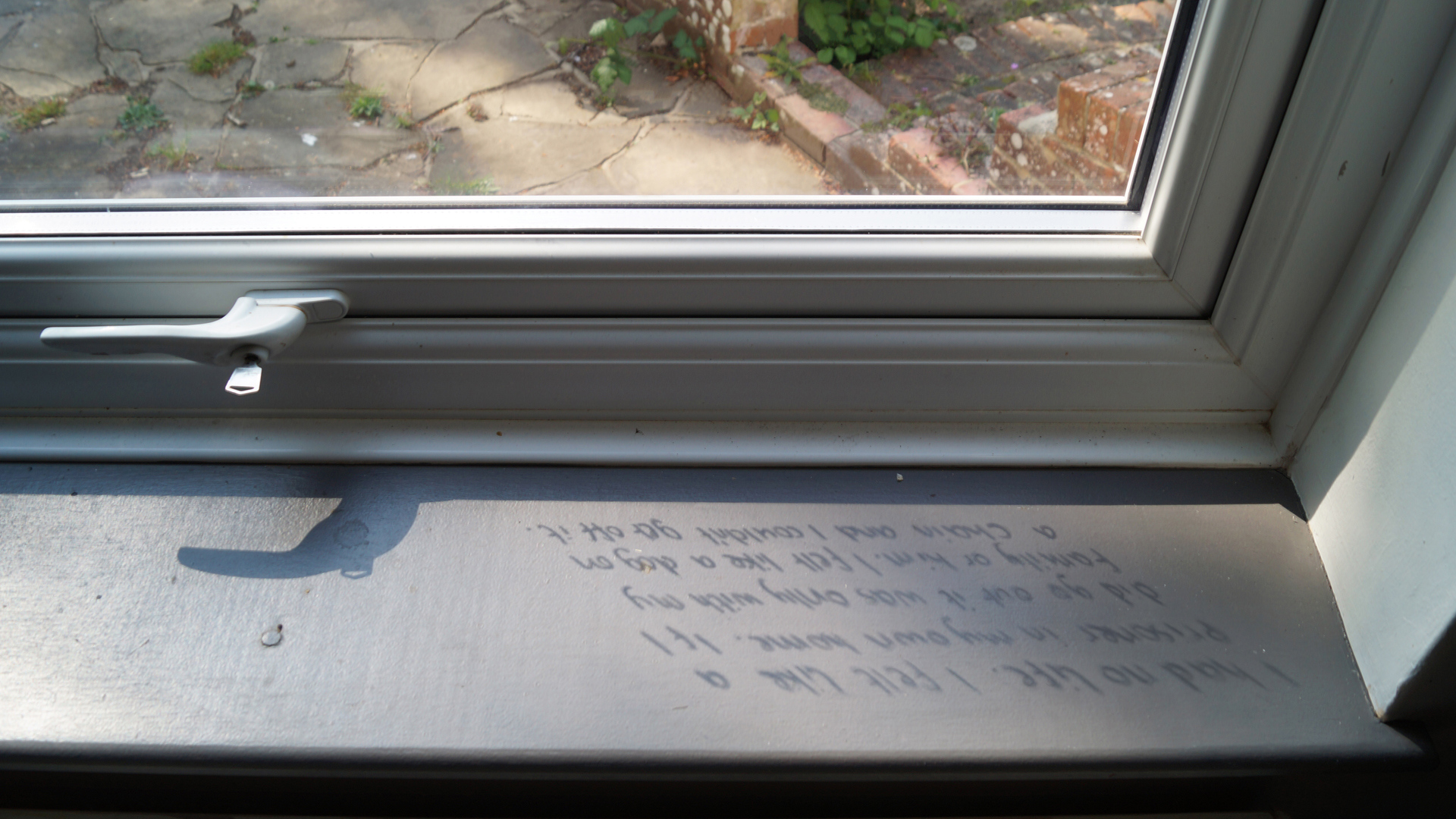 A window ledge with some writing on