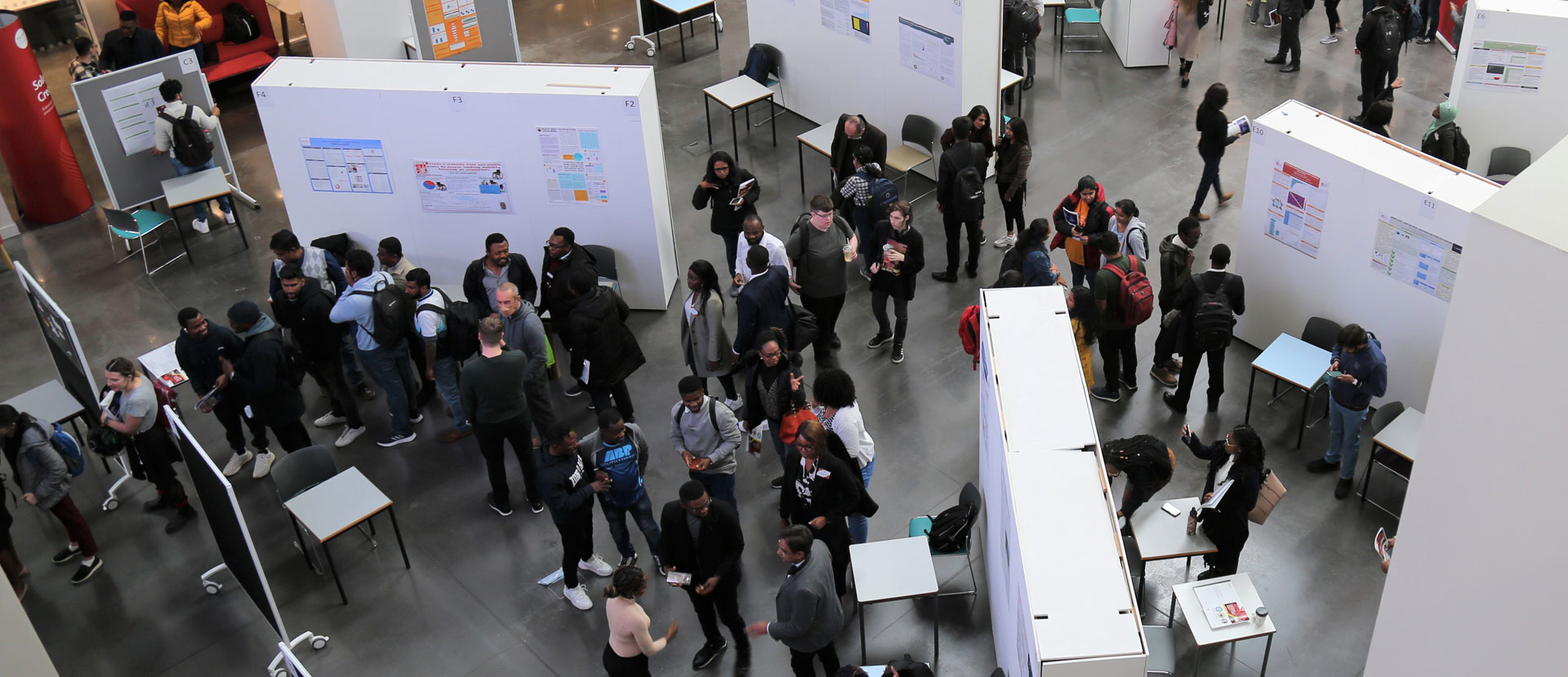 People looking at the poster exhibitions at the SCAIDS conference