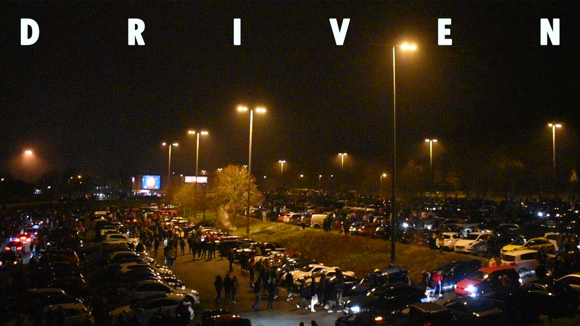 Image shows cars parked up, and the word 'Driven' 