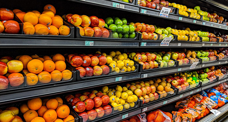 Rows of apples on a supermarket shelf