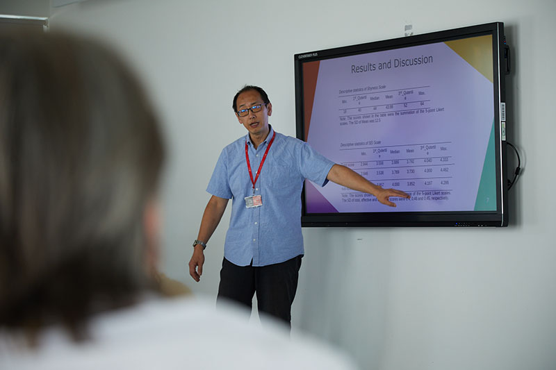 A person presenting their research on a screen