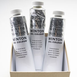 Three tubes of white paint in a box