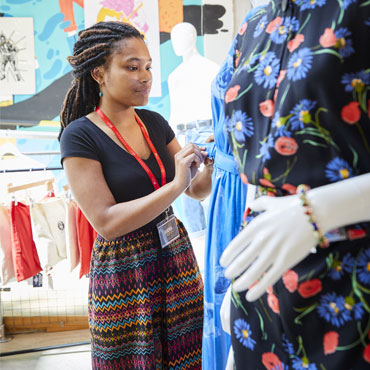 A student pinning a dress to a mannequin in Solent's Re:So store