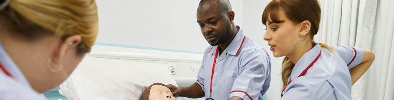 Three Solent nursing students in the nursing simulation suite