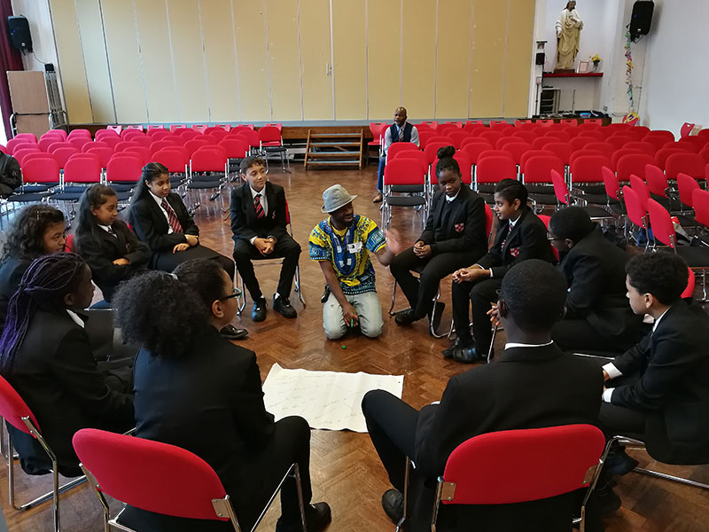 A person giving a talk in a school