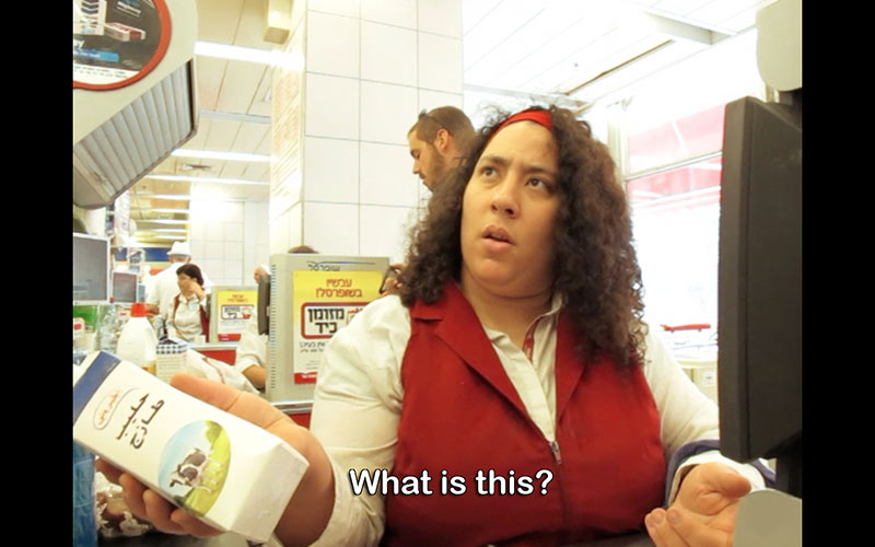 Still from a film showing a female shop assistant