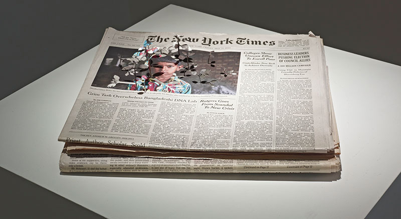 New York Times newspaper with paper leaves on it