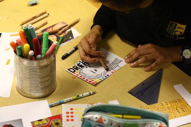 A school pupil creating their self portrait