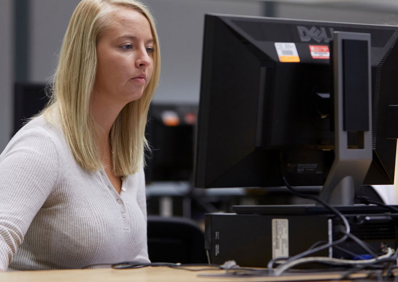 Woman looking at a computer monitor