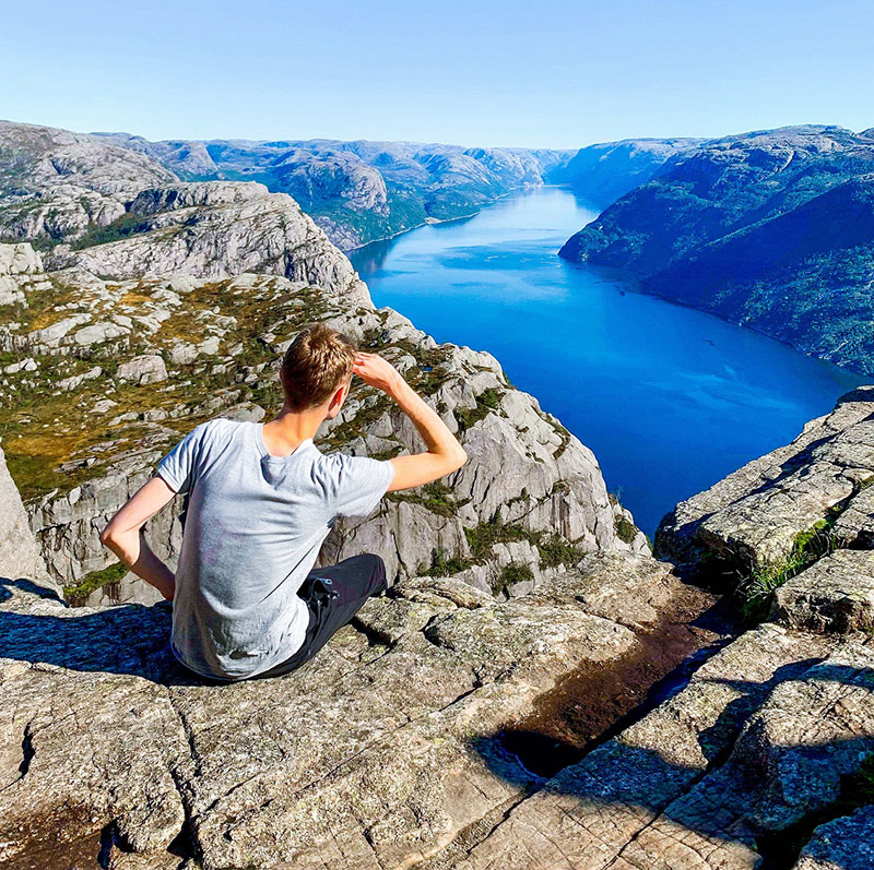 Graphic design student Aaron Wallace on a cliff in Oslo during his semester studying abroad